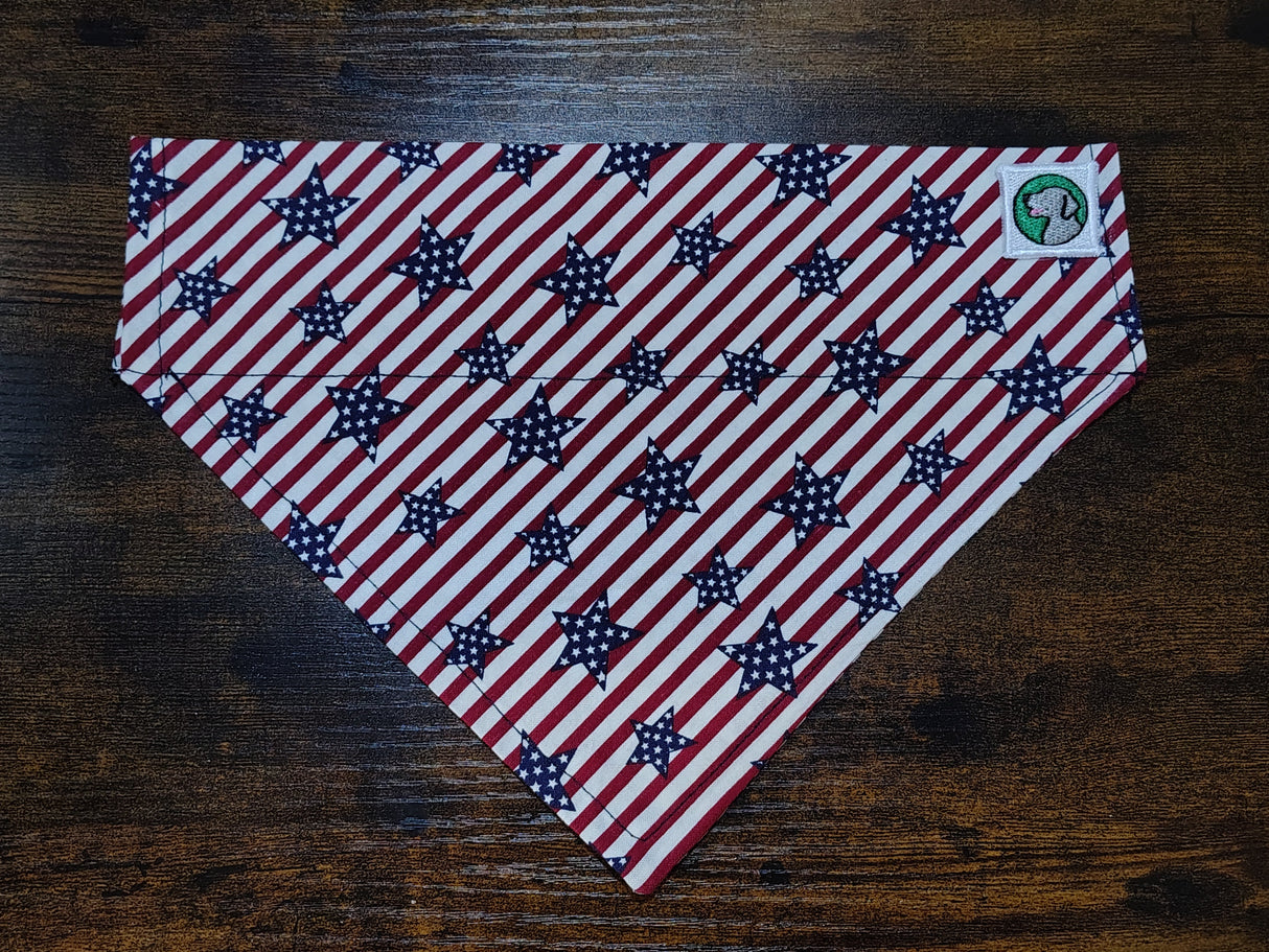 American flag patterned dog bandanna on a wooden surface