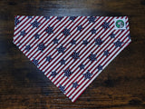 American flag patterned dog bandanna on a wooden surface