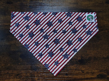 American flag patterned dog bandanna on a wooden surface