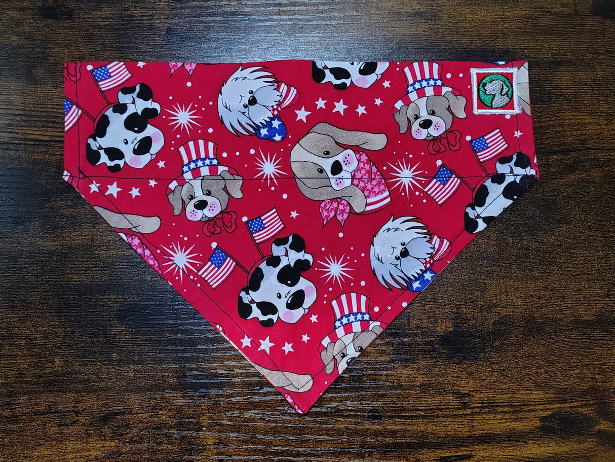 Red bandana with dog-themed pattern on a wooden surface