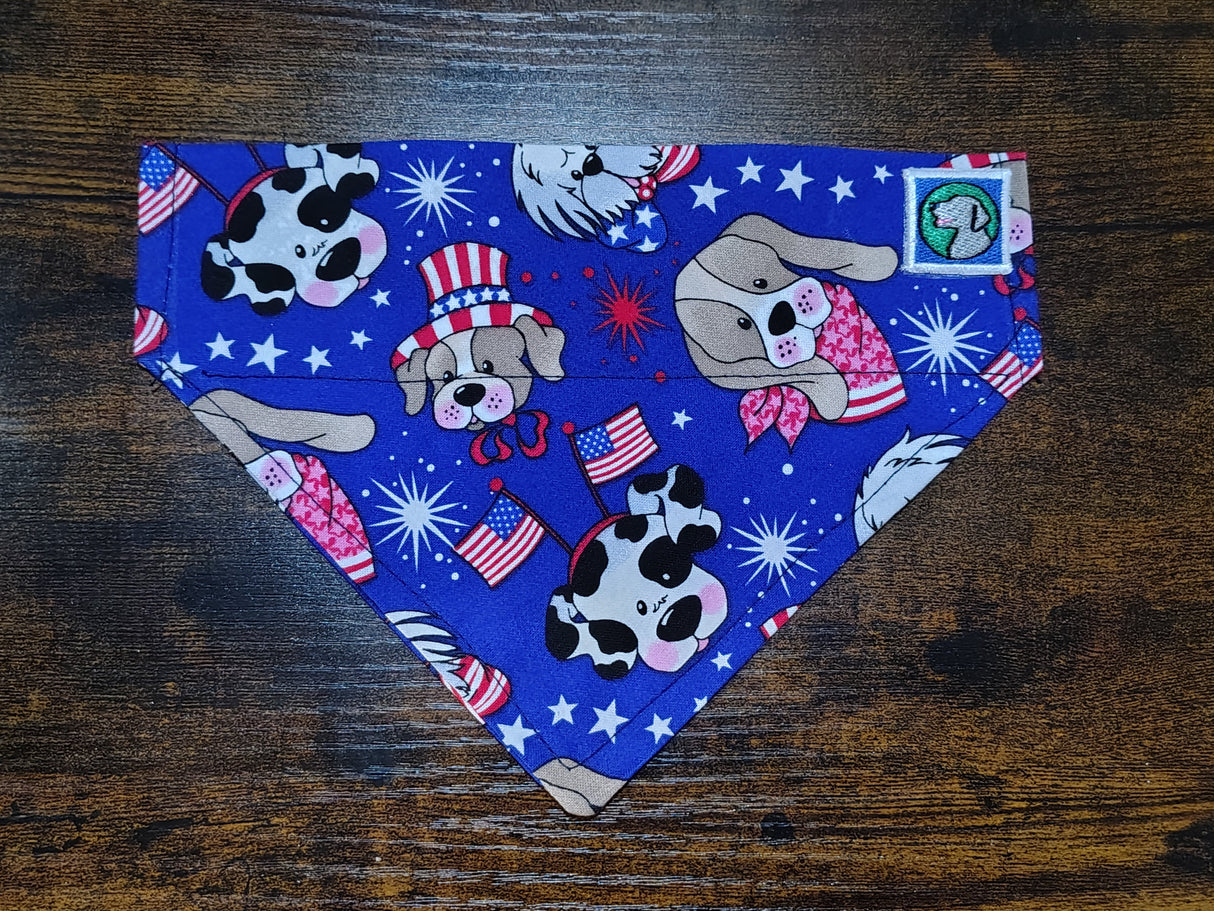 Dog bandanna with patriotic and cartoon-themed designs on a wooden surface