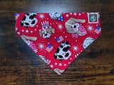 Red dog bandanna with animal patterns on a wooden surface