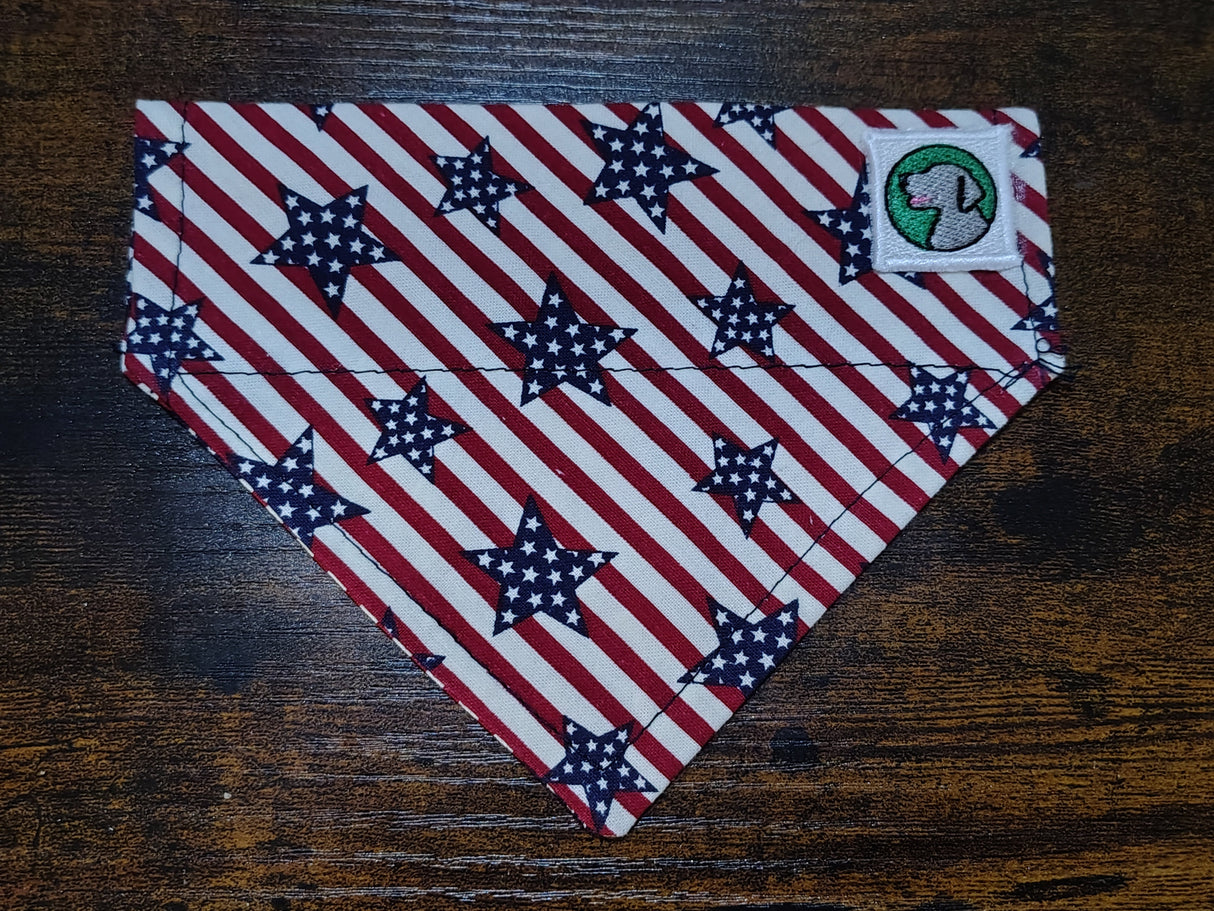 American flag patterned dog bandana with stars on a wooden surface