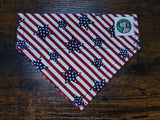 American flag patterned dog bandana with stars on a wooden surface