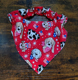 Red bandana with dog-themed pattern on a wooden surface