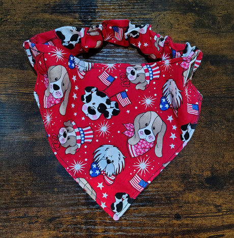 Red bandana with dog-themed pattern on a wooden surface