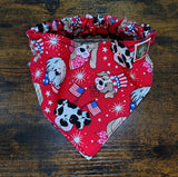 Red bandana with dog-themed pattern on a wooden surface