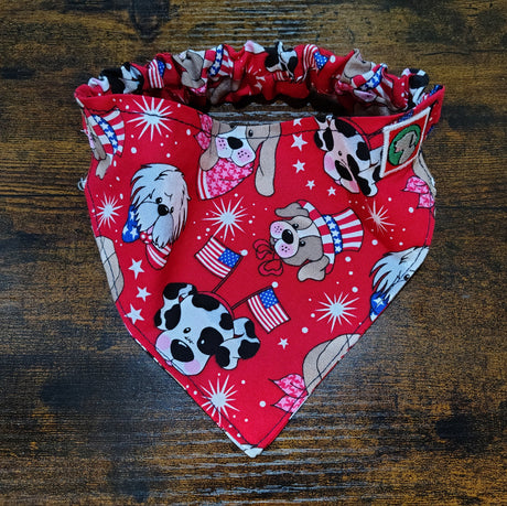 Red bandana with dog-themed pattern on a wooden surface