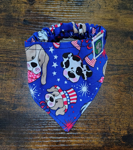 Blue bandana with dog-themed designs on a wooden surface