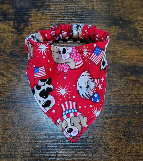 Red bandana with dog-themed print on a wooden surface