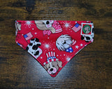 Red bandana with dog-themed designs on a wooden surface