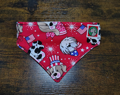 Red bandana with dog-themed designs on a wooden surface